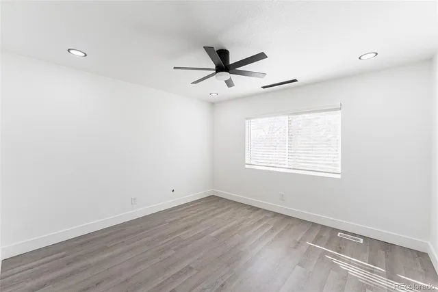 a view of a room with wooden floor and windows