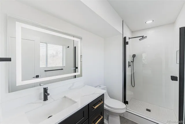 a bathroom with a sink a toilet and a mirror