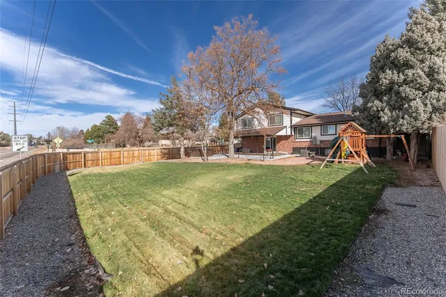a view of a house with a backyard