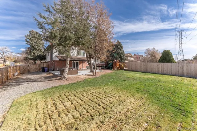a view of a house with backyard and sitting area