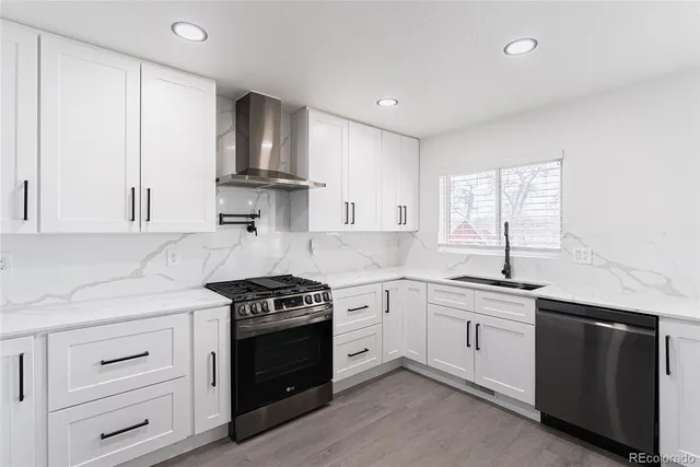 a kitchen with white cabinets stainless steel appliances and sink