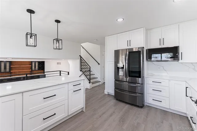 a kitchen with appliances cabinets and a sink