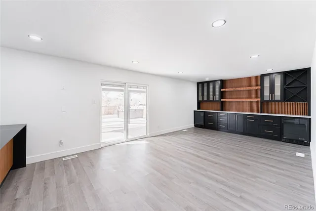 a view of kitchen with wooden floor and electronic appliances