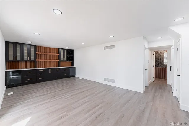 a view of an empty room with wooden floor