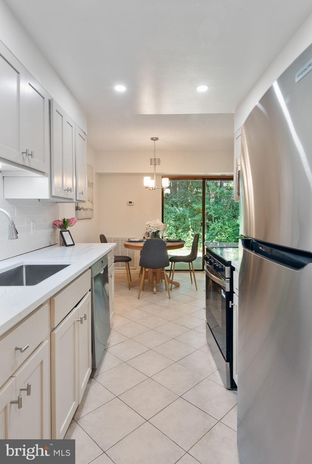 11600 Stoneview Square, Unit 60/2B Reston, VA 20191 - Photo 17 of 27 a kitchen with stainless steel appliances granite countertop a refrigerator sink and cabinets