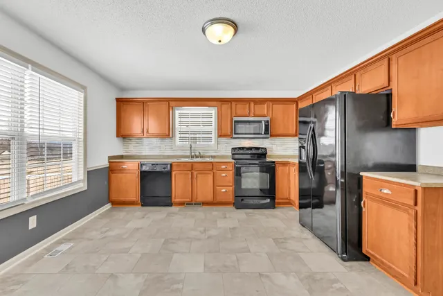 a kitchen with stainless steel appliances a refrigerator and a stove