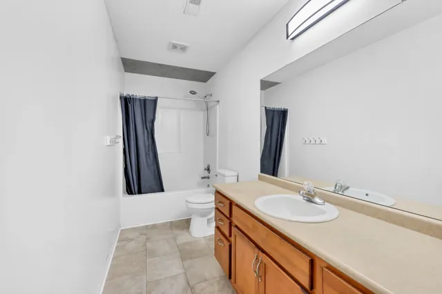 an empty room with closet and fan