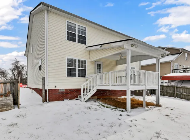 a view of a house with wooden fence