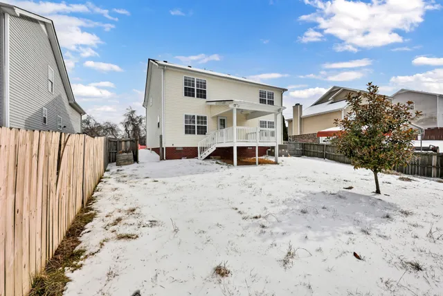 a view of a house with a snow in the yard