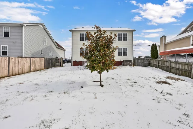 a view of a house with wooden fence