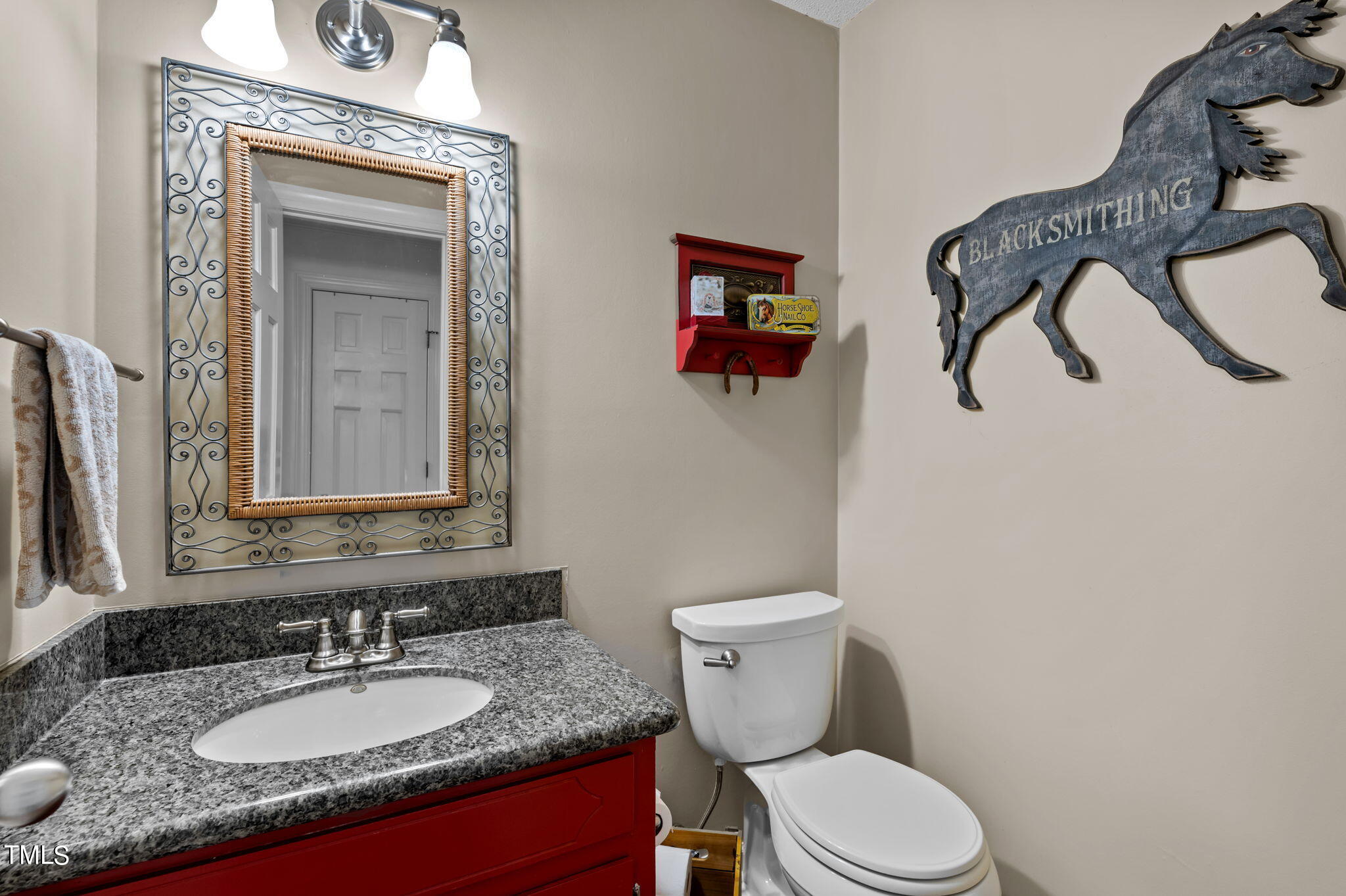 7929 Ragan Road Apex, NC 27502 - Photo 54 of 89 a bathroom with a granite countertop toilet sink and mirror