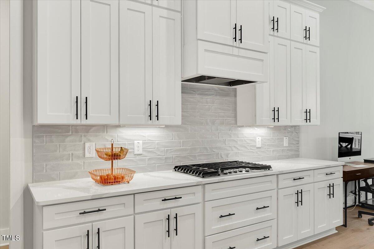 3812 Stoneridge Drive Raleigh, NC 27612 - Photo 11 of 46 a kitchen with white cabinets and a sink