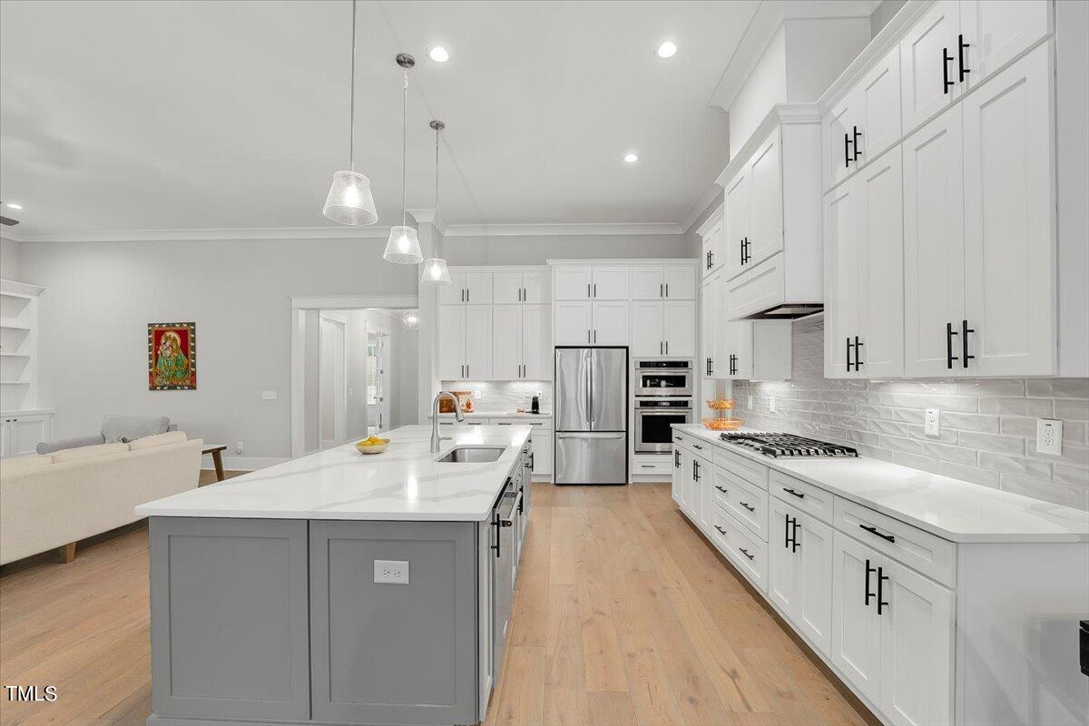 3812 Stoneridge Drive Raleigh, NC 27612 - Photo 12 of 46 a kitchen with counter top space a sink cabinets and appliances