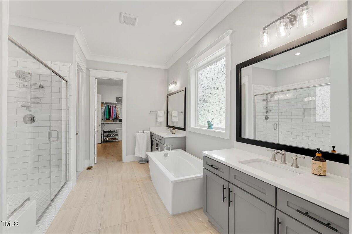 3812 Stoneridge Drive Raleigh, NC 27612 - Photo 18 of 46 a bathroom with a double vanity sink mirror and shower