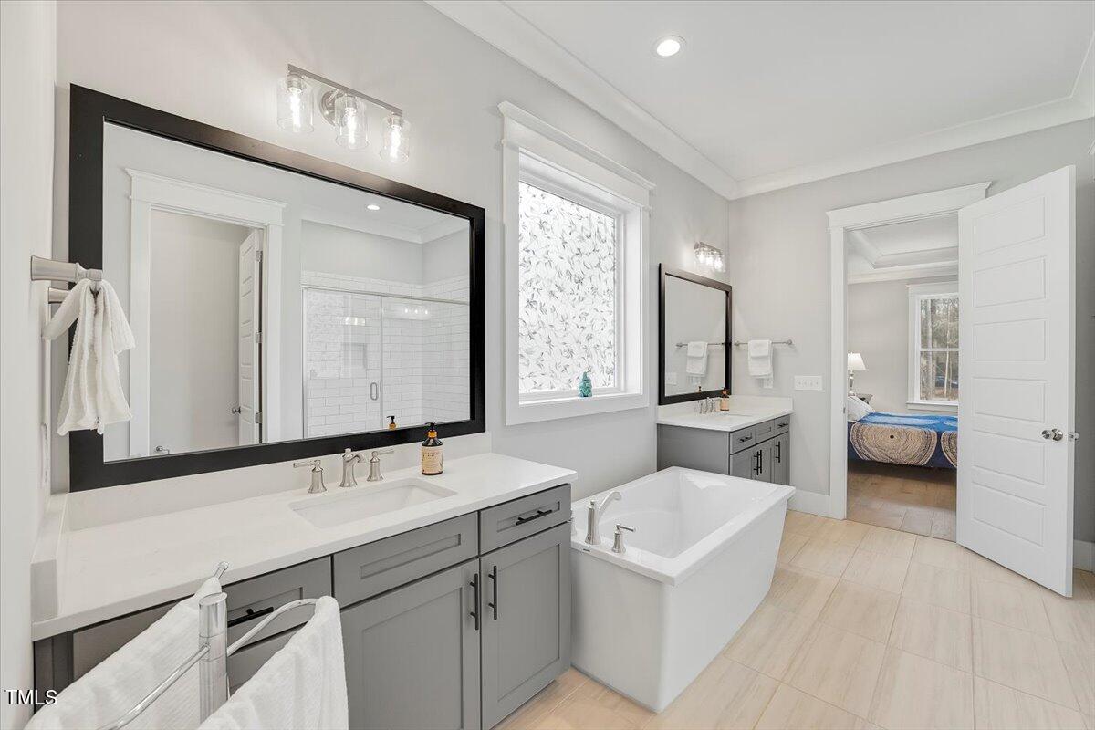 3812 Stoneridge Drive Raleigh, NC 27612 - Photo 20 of 46 a en suite bathroom with a double vanity sink a mirror and a shower