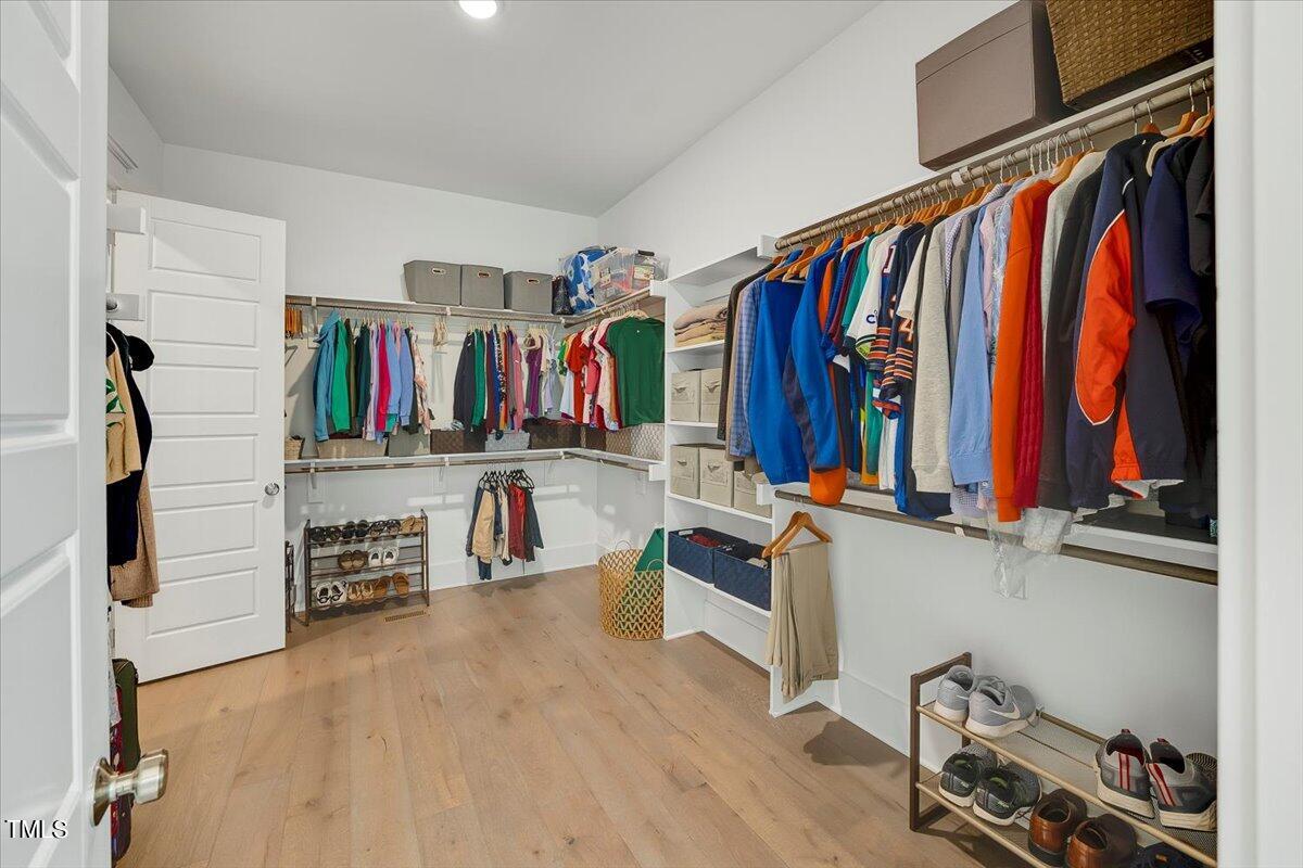3812 Stoneridge Drive Raleigh, NC 27612 - Photo 21 of 46 a view of walk in closet with clothes and shoes