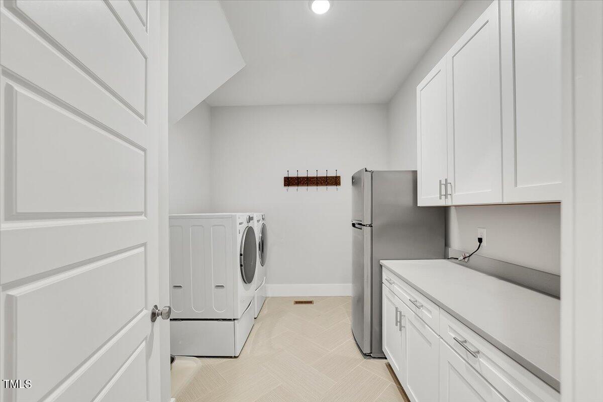 3812 Stoneridge Drive Raleigh, NC 27612 - Photo 22 of 46 a kitchen with white cabinets and white appliances