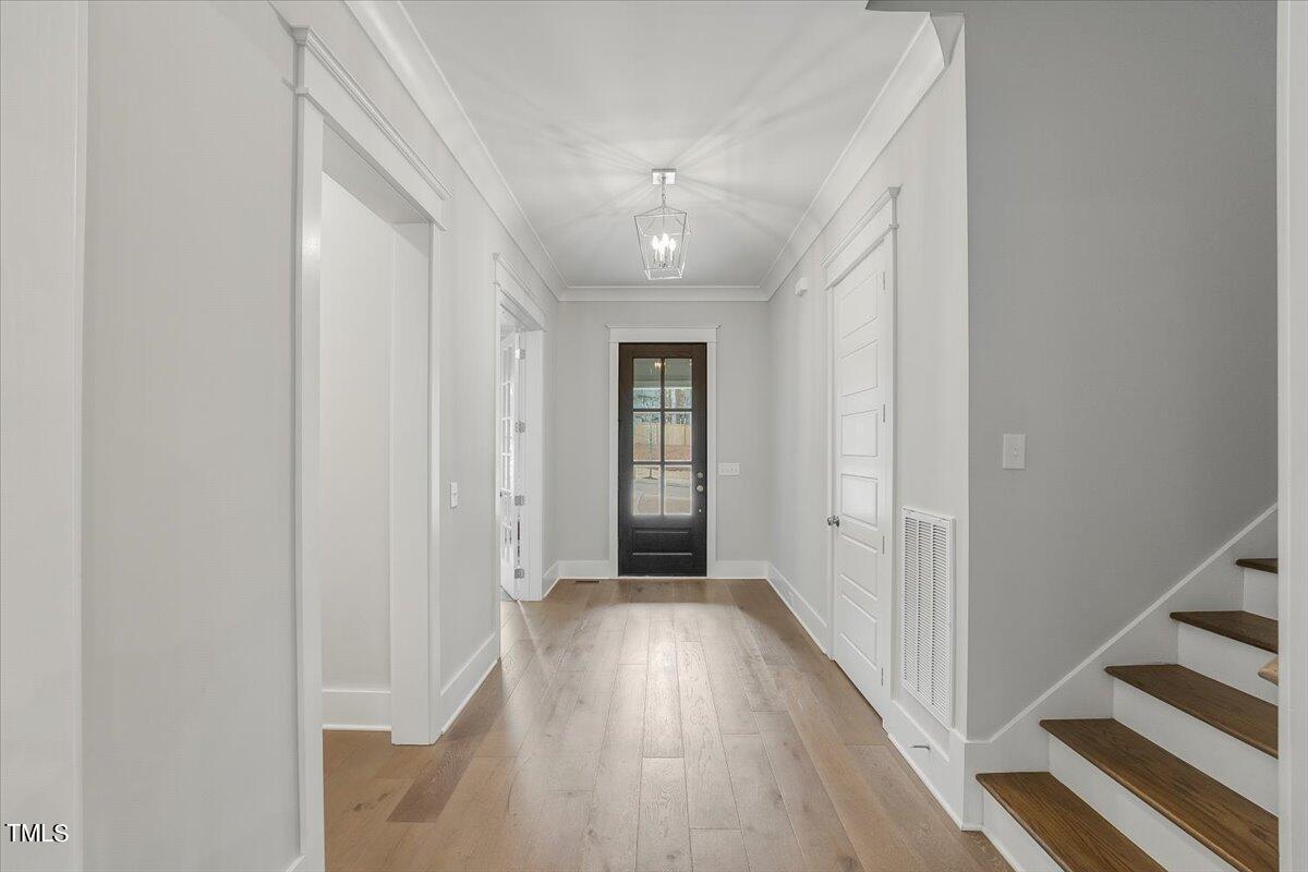 3812 Stoneridge Drive Raleigh, NC 27612 - Photo 26 of 46 a view of a hallway with wooden floor and entryway