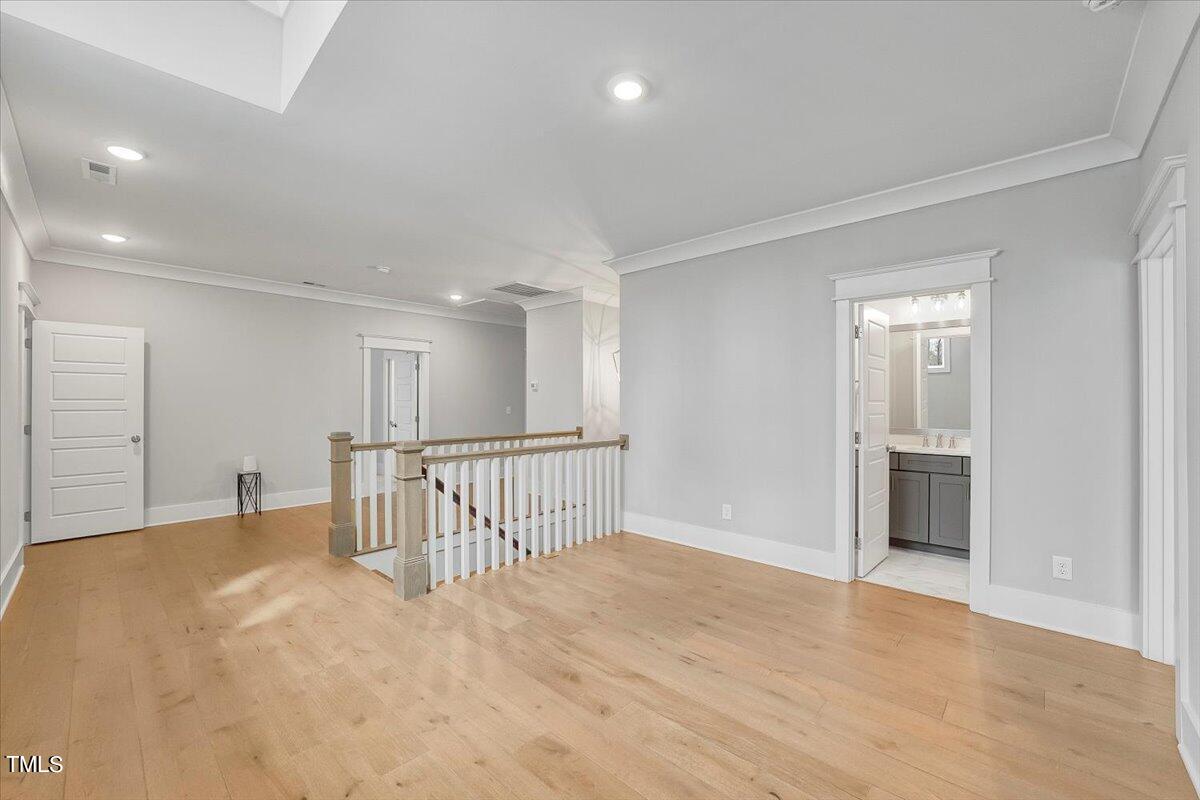 3812 Stoneridge Drive Raleigh, NC 27612 - Photo 27 of 46 a view of a hallway with wooden floor
