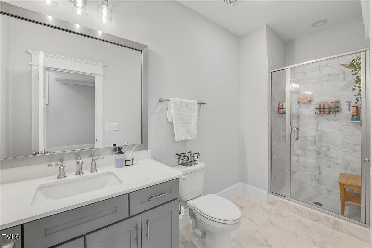3812 Stoneridge Drive Raleigh, NC 27612 - Photo 29 of 46 a bathroom with a sink a toilet a mirror and shower