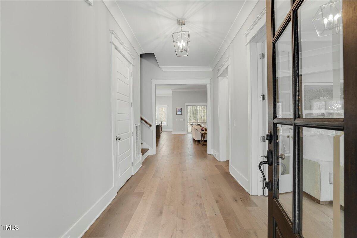 3812 Stoneridge Drive Raleigh, NC 27612 - Photo 3 of 46 a view of a hallway with wooden floor and staircase