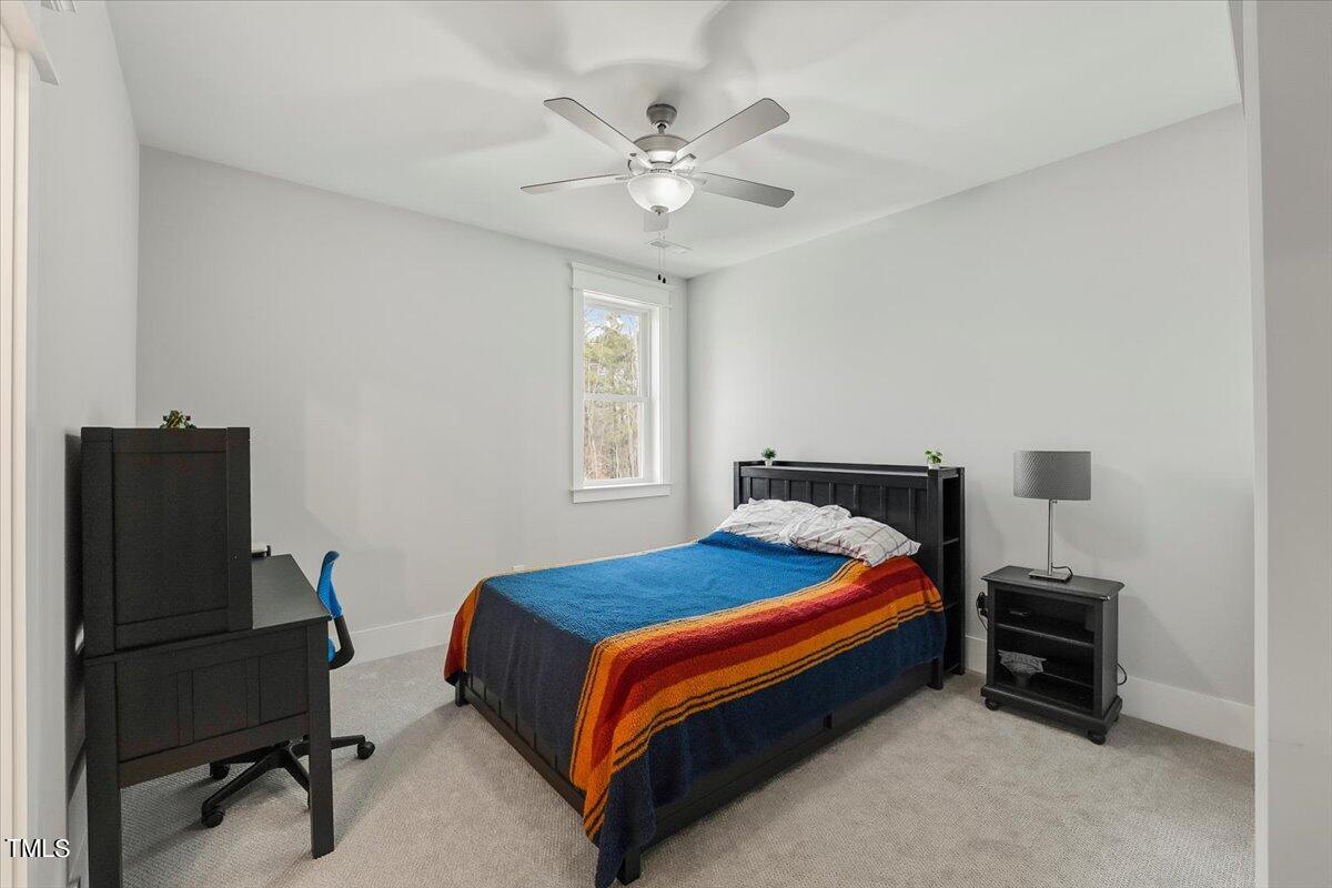 3812 Stoneridge Drive Raleigh, NC 27612 - Photo 31 of 46 a bedroom with a bed and a ceiling fan