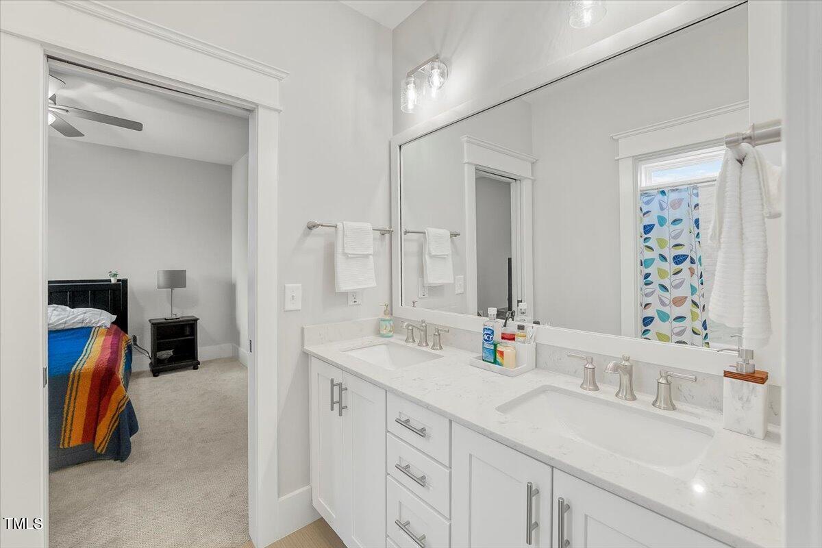 3812 Stoneridge Drive Raleigh, NC 27612 - Photo 33 of 46 a bathroom with a sink double vanity and a mirror