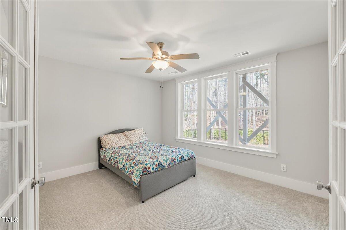 3812 Stoneridge Drive Raleigh, NC 27612 - Photo 42 of 46 a spacious bedroom with a bed and a window