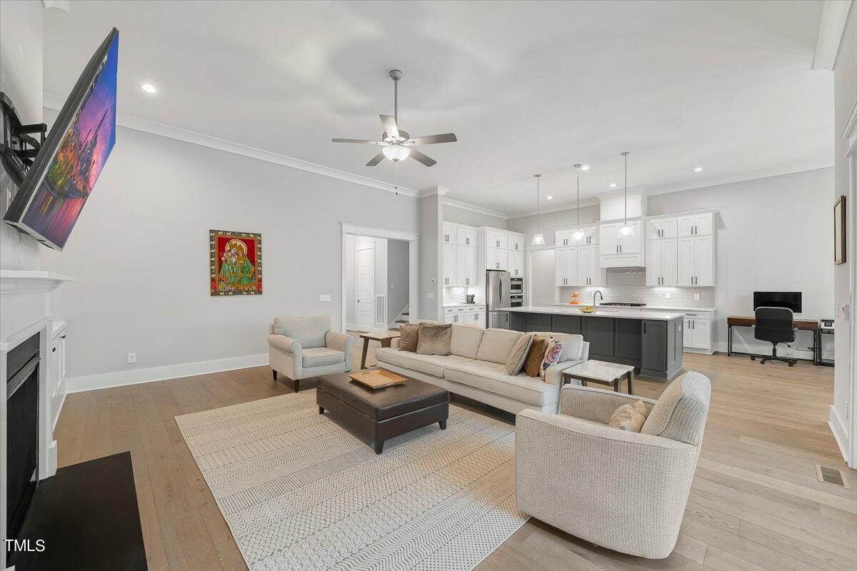 3812 Stoneridge Drive Raleigh, NC 27612 - Photo 6 of 46 a living room with furniture kitchen view and a fireplace