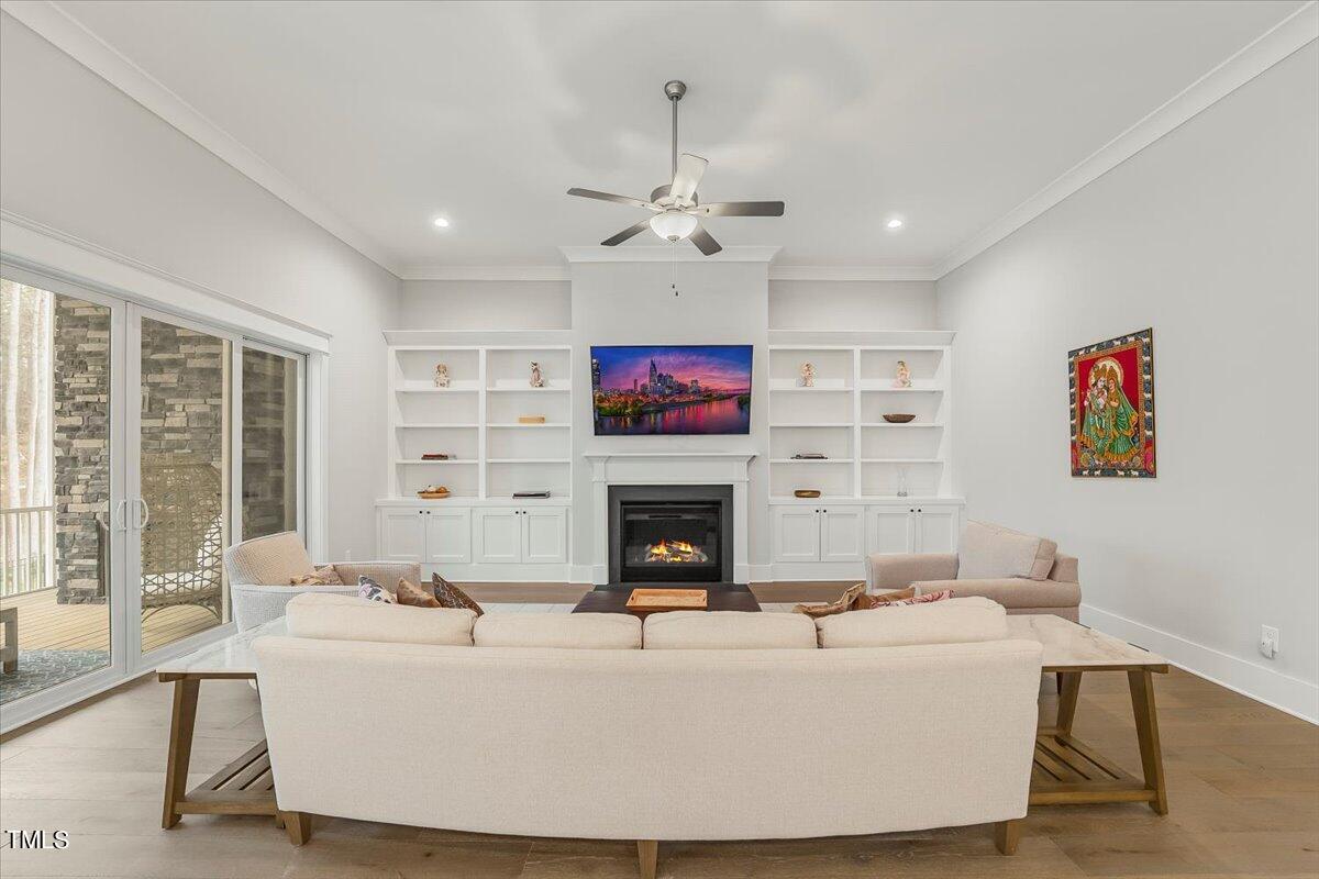 3812 Stoneridge Drive Raleigh, NC 27612 - Photo 8 of 46 a living room with furniture a fireplace and a large window