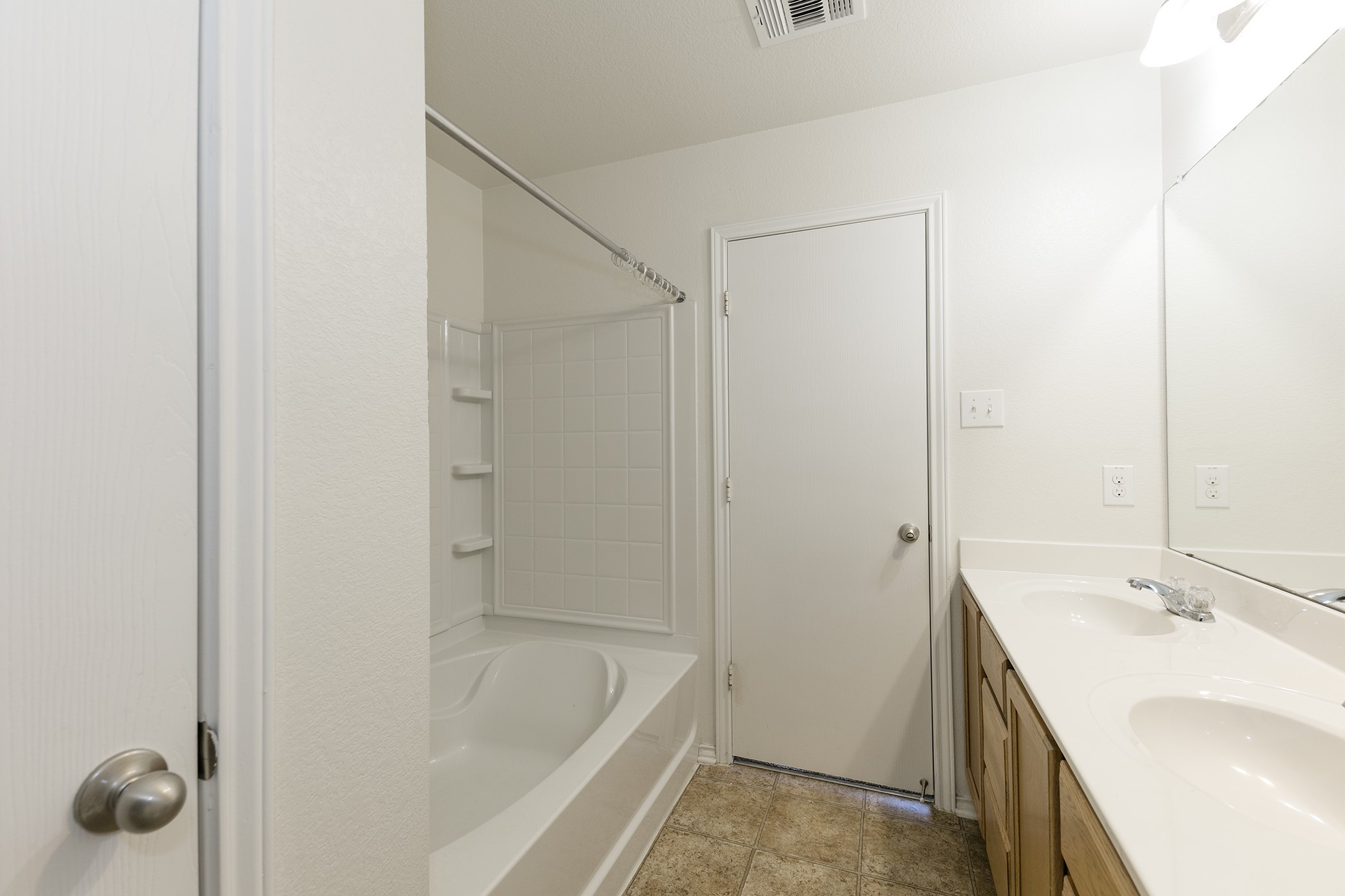 1141 Renaissance Trail Round Rock, TX 78665 - Photo 10 of 23 A pristine bathroom features a shower/tub combination and a practical double vanity, ready for daily routines.