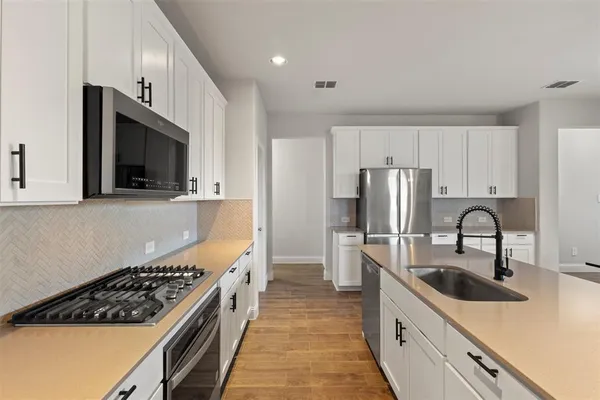 a kitchen that has a sink and cabinets in it