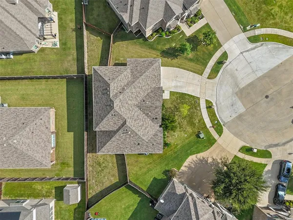 an aerial view of residential houses with outdoor space and ocean view