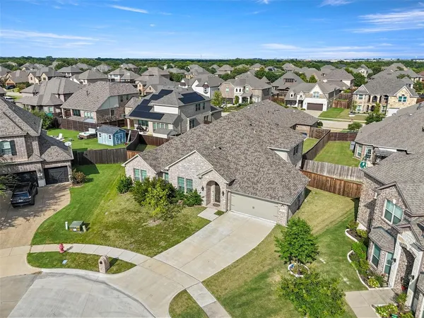 an aerial view of residential houses with outdoor space