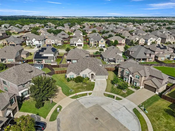 an aerial view of a city with lots of residential buildings and mountain view in back