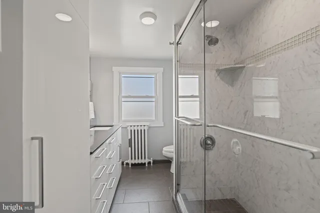 a bathroom with a shower and a sink