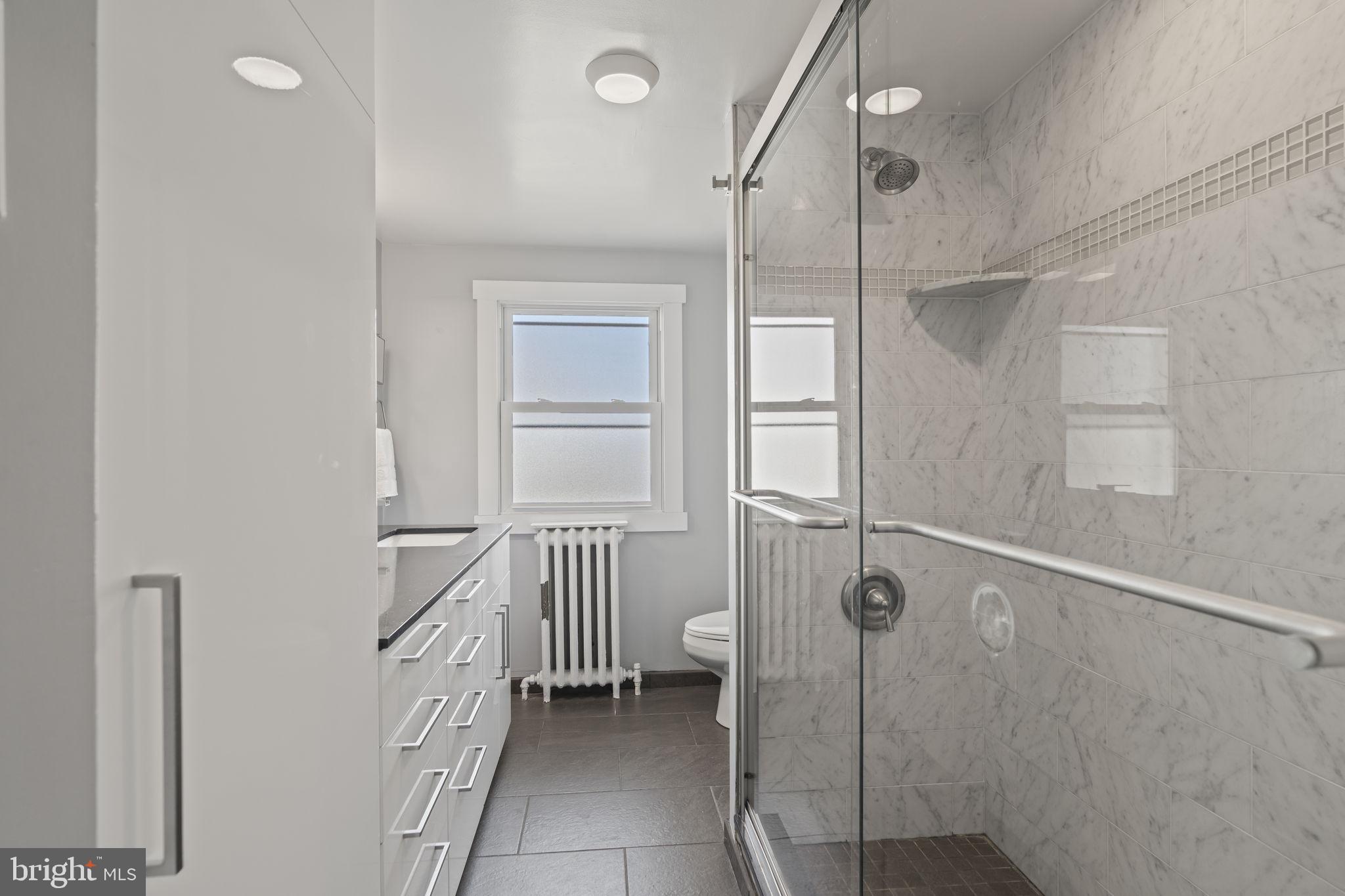 2173 East Hagert Street Philadelphia, PA 19125 - Photo 16 of 23 a bathroom with a shower and a sink