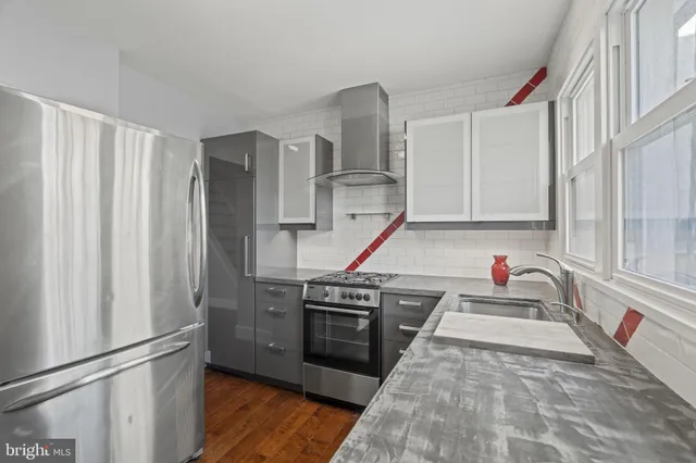 a kitchen with stainless steel appliances granite countertop a refrigerator and a sink