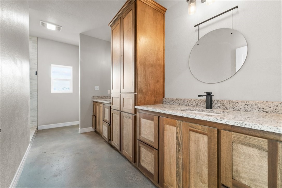 207 South Charles Street George West, TX 78022 - Photo 23 of 24 a bathroom with double vanity and a mirror