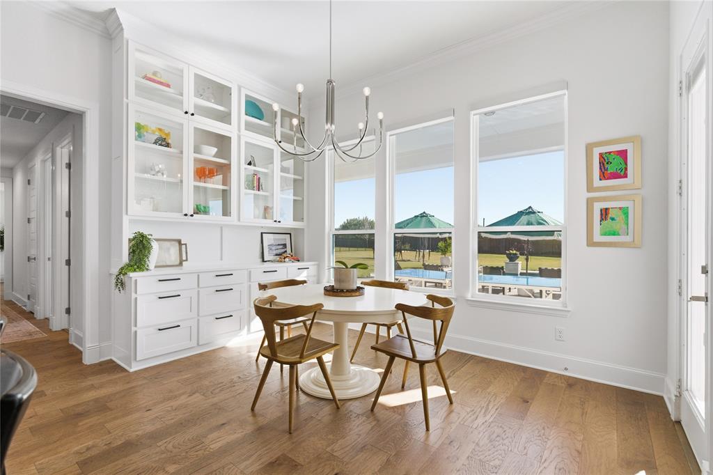 7754 Barber Rnch Road Fort Worth, TX 76126 - Photo 12 of 38 a view of a dining room with furniture a chandelier and wooden floor