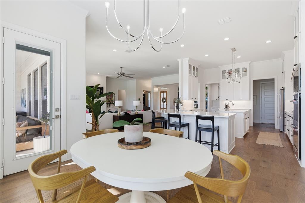 7754 Barber Rnch Road Fort Worth, TX 76126 - Photo 13 of 38 a dining room with stainless steel appliances kitchen island granite countertop a table chairs and a refrigerator