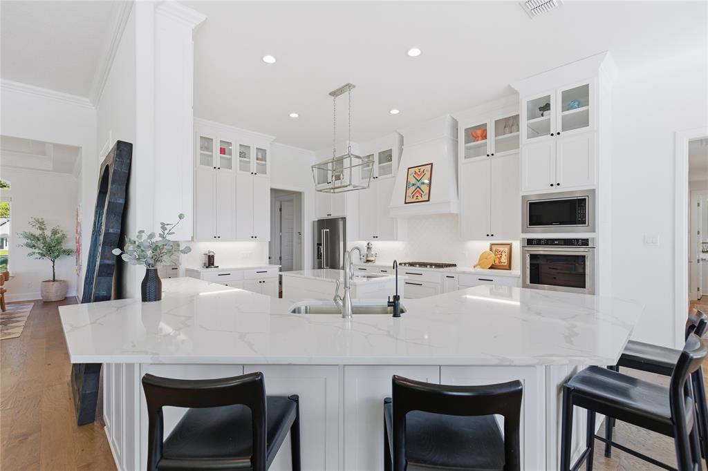 7754 Barber Rnch Road Fort Worth, TX 76126 - Photo 14 of 38 a kitchen with stainless steel appliances kitchen island granite countertop a table chairs microwave and sink