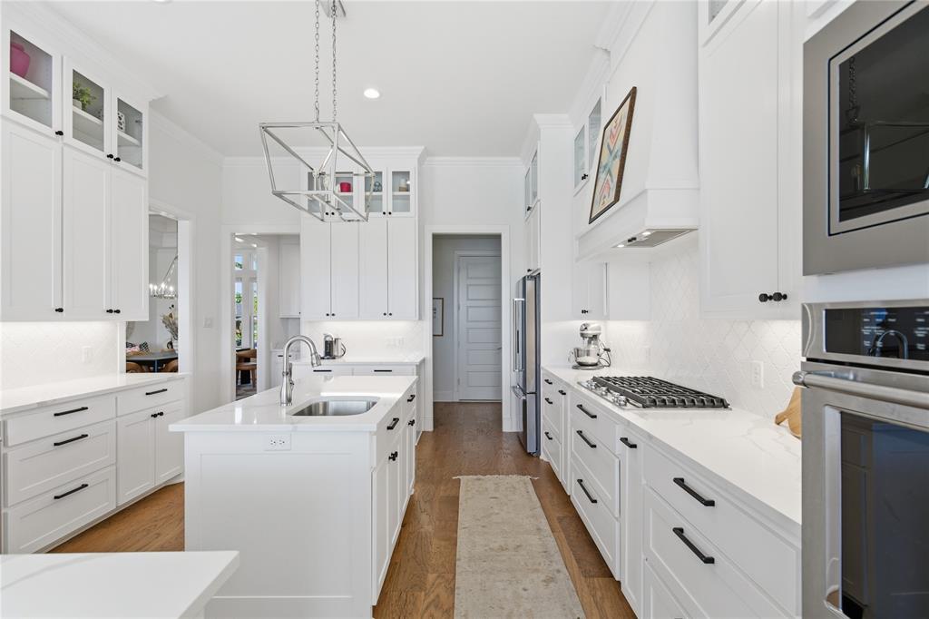 7754 Barber Rnch Road Fort Worth, TX 76126 - Photo 16 of 38 a large white kitchen with cabinets a sink a window and stainless steel appliances