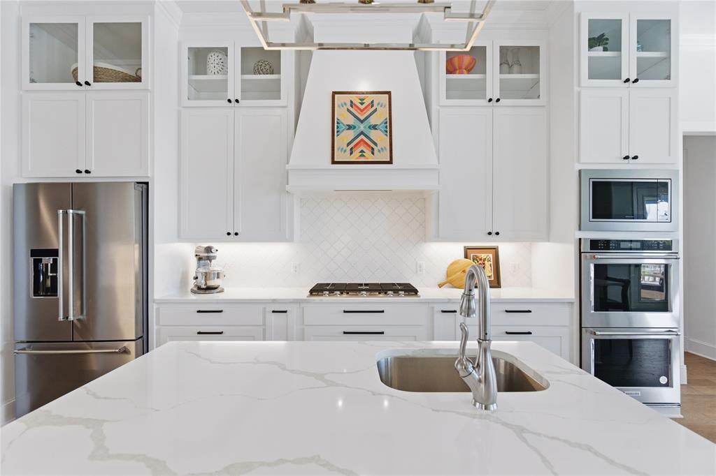 7754 Barber Rnch Road Fort Worth, TX 76126 - Photo 17 of 38 a kitchen with a refrigerator and a stove top oven