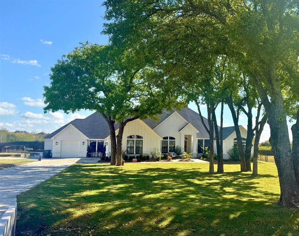 7754 Barber Rnch Road Fort Worth, TX 76126 - Photo 2 of 38 a view of house with garden and tall trees