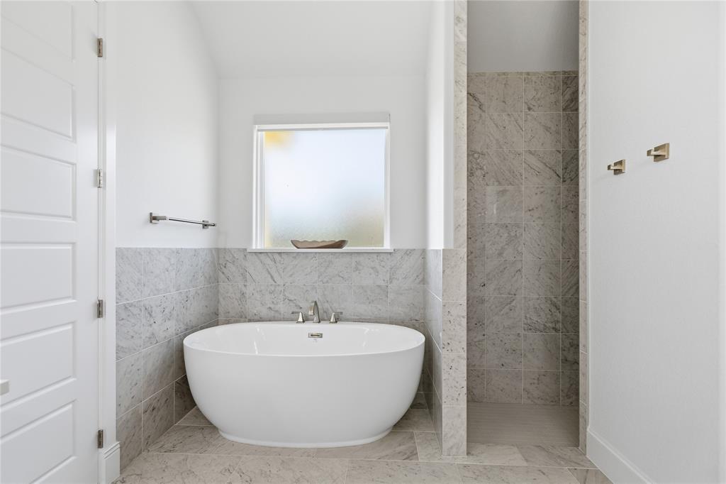 7754 Barber Rnch Road Fort Worth, TX 76126 - Photo 22 of 38 a bathroom with a bathtub and shower