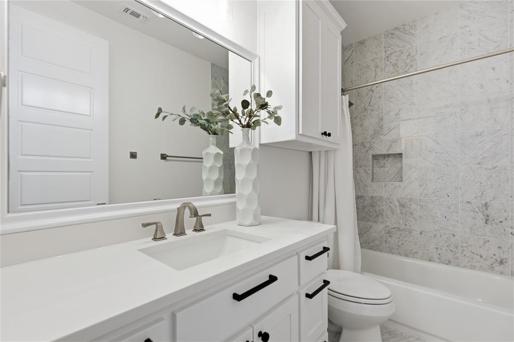 7754 Barber Rnch Road Fort Worth, TX 76126 - Photo 24 of 38 a bathroom with a sink a toilet and shower