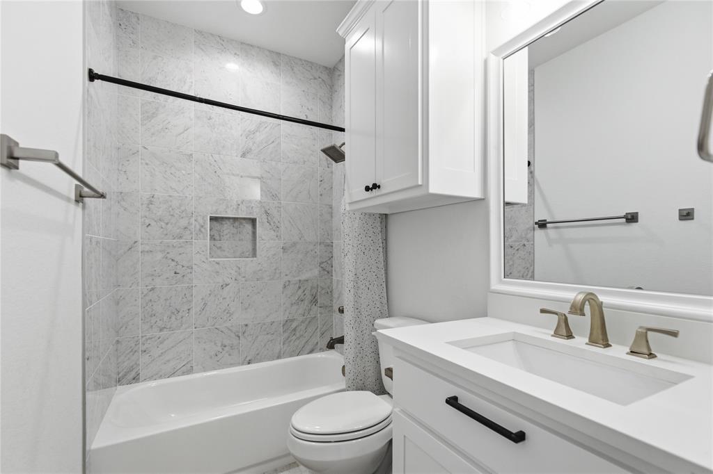 7754 Barber Rnch Road Fort Worth, TX 76126 - Photo 28 of 38 a bathroom with a bathtub shower sink vanity mirror and toilet