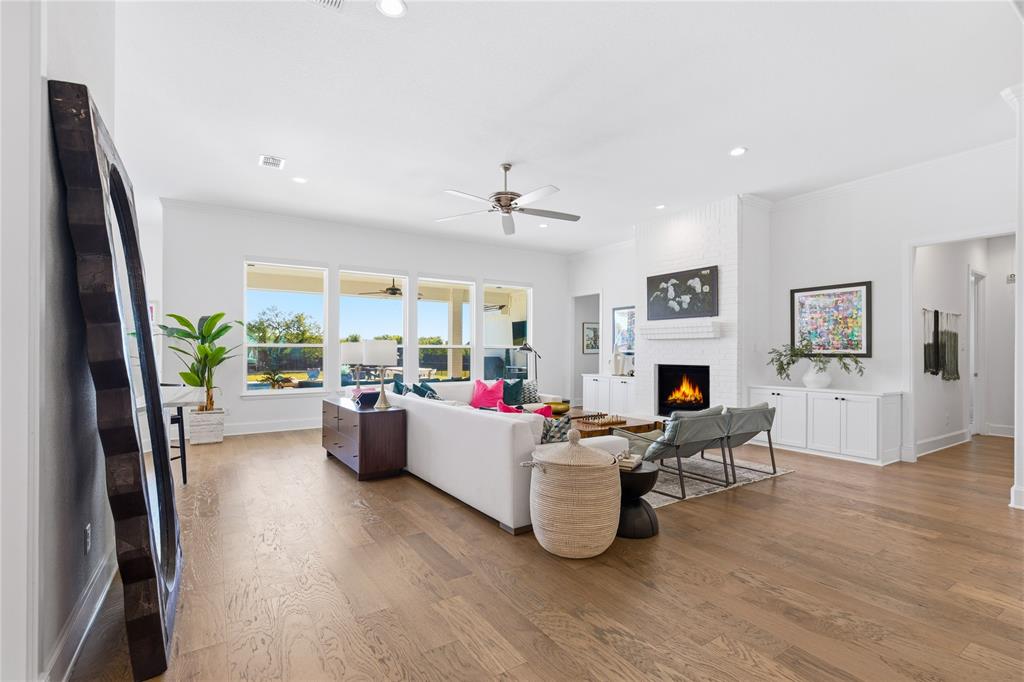 7754 Barber Rnch Road Fort Worth, TX 76126 - Photo 7 of 38 a living room with furniture a fireplace and a flat screen tv