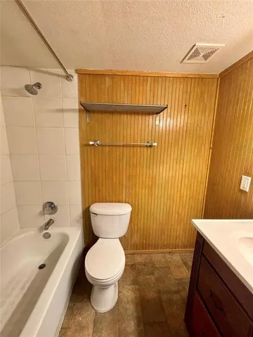 a bathroom with a toilet sink and shower